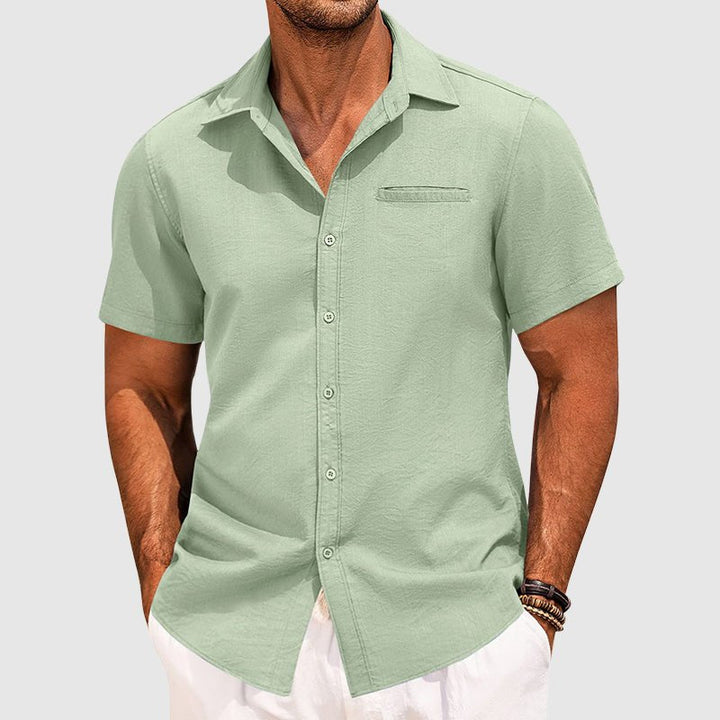 Front view of a men's stylish button-down summer shirt, short sleeve, with a chest pocket, ideal for warm weather.