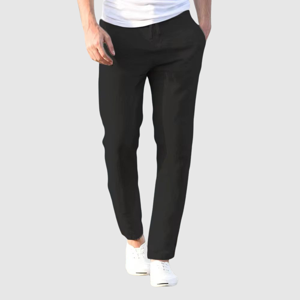 Model wears men's versatile lightweight drawstring pants, ideal for a relaxed everyday look or comfortable travel.