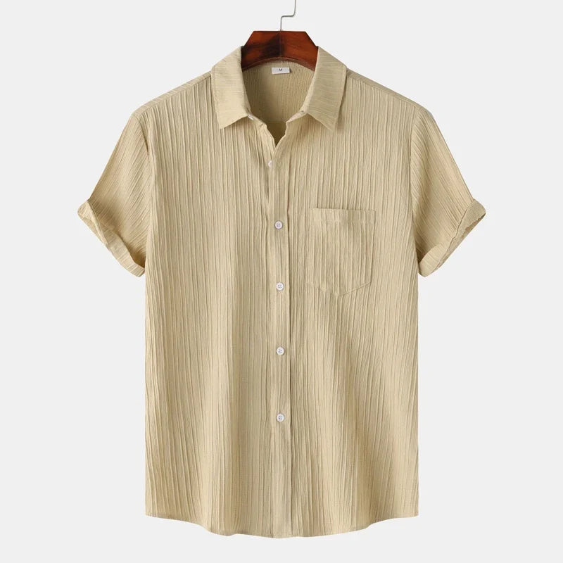 Short-sleeve men's button-down shirt with coastal vibes. Lightweight & comfortable for versatile summer fashion.