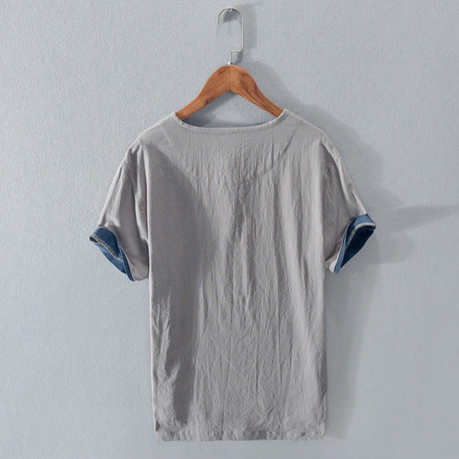 Close-up of the breathable fabric of a men's lightweight Henley shirt, ideal for comfortable summer style.