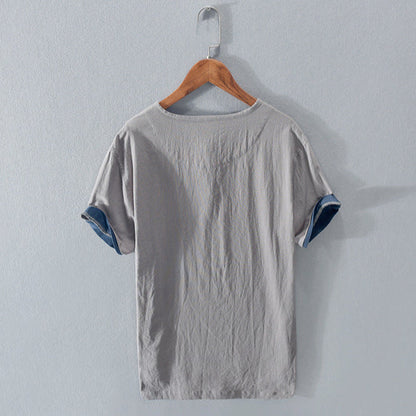 Close-up of the breathable fabric of a men's lightweight Henley shirt, ideal for comfortable summer style.