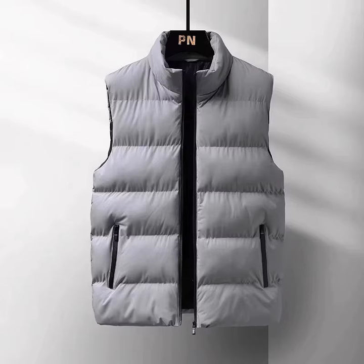 Stylish men's puffer vest in black, providing lightweight warmth and wind protection for winter fashion & activewear.