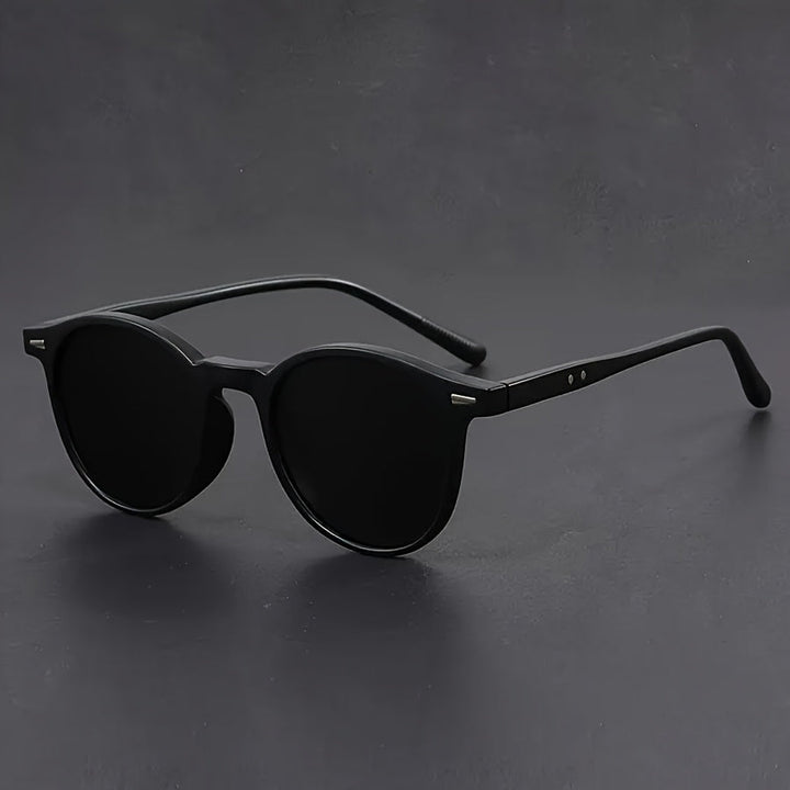 Close-up of men's retro round tortoiseshell sunglasses, highlighting the unique pattern and lightweight frame.