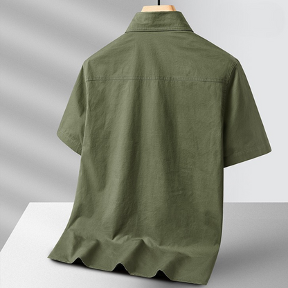 Close-up of men's adventure field shirt, showing durable lightweight fabric and utility pockets for outdoor wear.