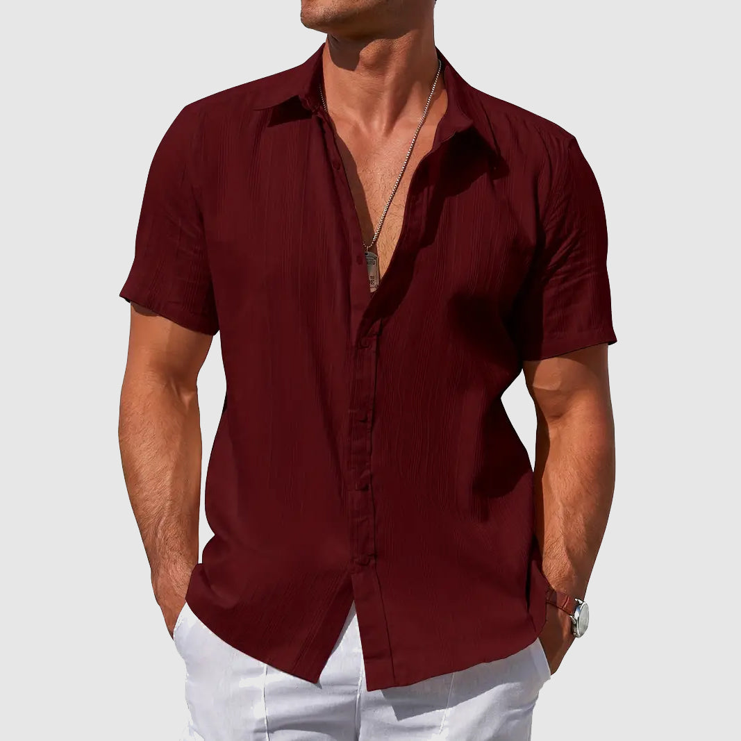 Detail of men's lightweight summer top, showing relaxed fit, short sleeve & breathable fabric texture.