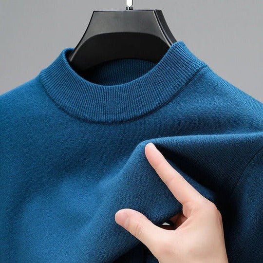 Stylish man models a black mock neck pullover sweater, perfect for a smart casual men's look.