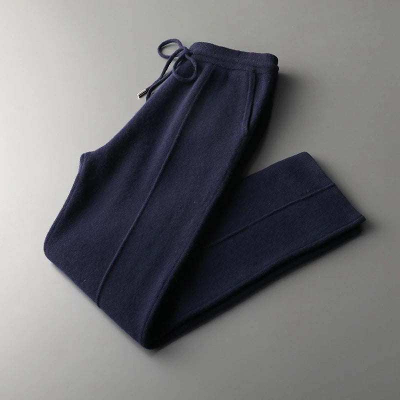 Man wearing comfortable men's cashmere blend lounge trousers with a practical drawstring waist.