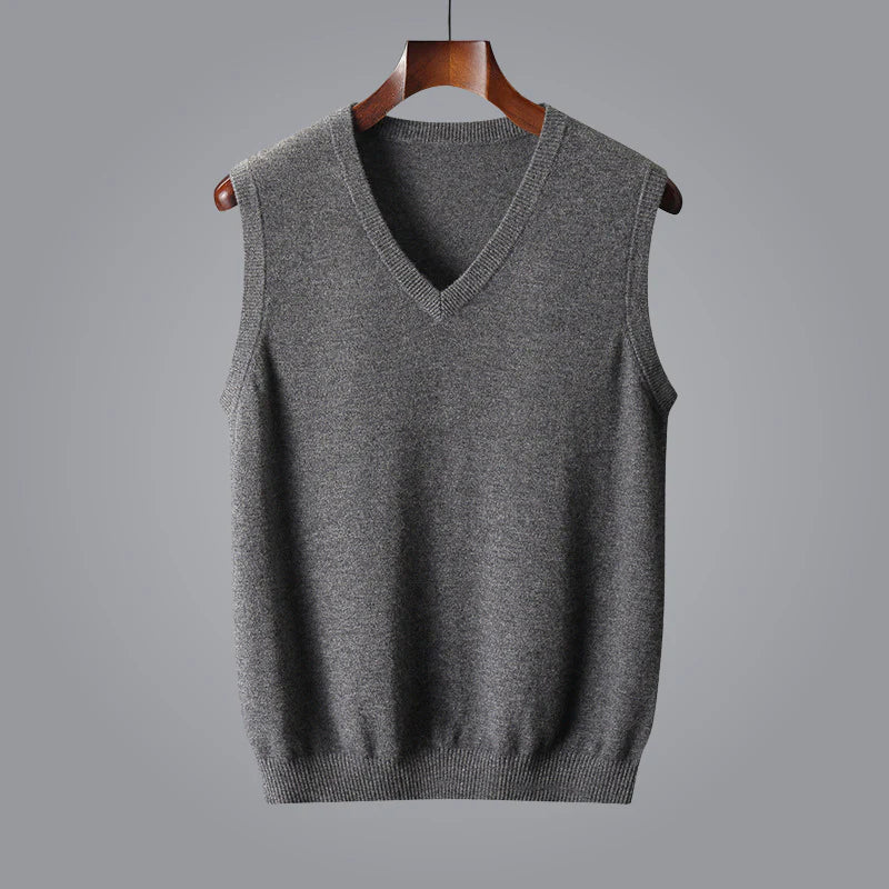 Man in tailored suit with luxurious cashmere V-neck vest, a sophisticated layering piece for men.