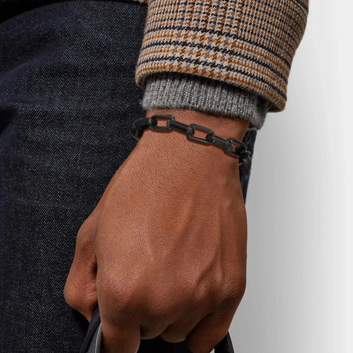 Men's luxury chain link bracelet on wrist, adding a bold and sophisticated touch to any outfit.