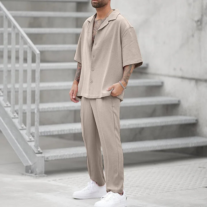 Stylish khaki men's long-sleeve button shirt & relaxed fit pants set. Comfortable luxury outfit.