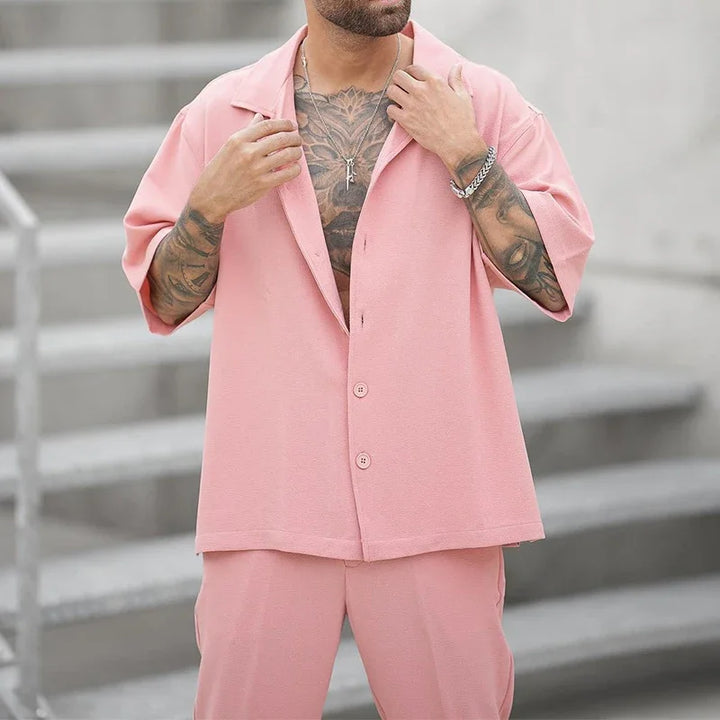 Men's luxury button shirt and sophisticated pants set. Elegant and versatile two-piece outfit.