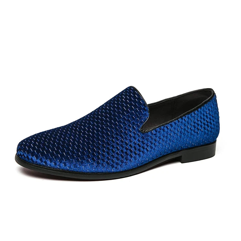 Sleek men's black leather slip-on loafers with intricate stitching, offering a luxury formal look.