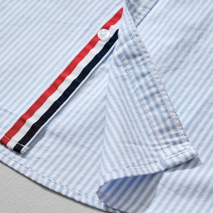 Close-up of Men's Milo striped casual shirt, showing blue & gray pattern. Lightweight fabric for men's summer style.