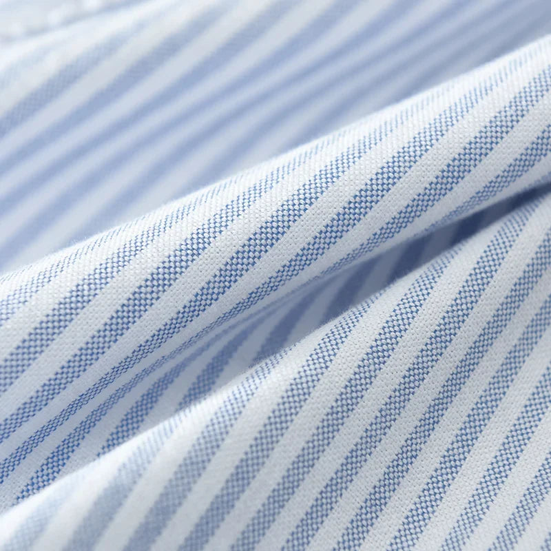 Man wearing Men's Milo striped casual button-down shirt in blue & gray. Lightweight & comfortable everyday top.