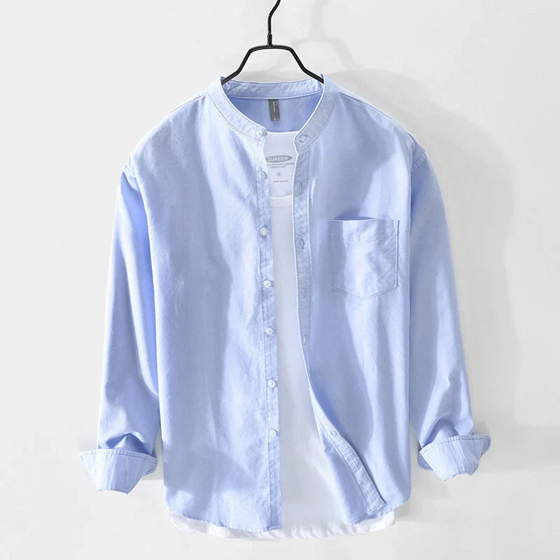 Modern men's minimal band collar shirt in a relaxed fit. Ideal for casual summer days or smart casual events.