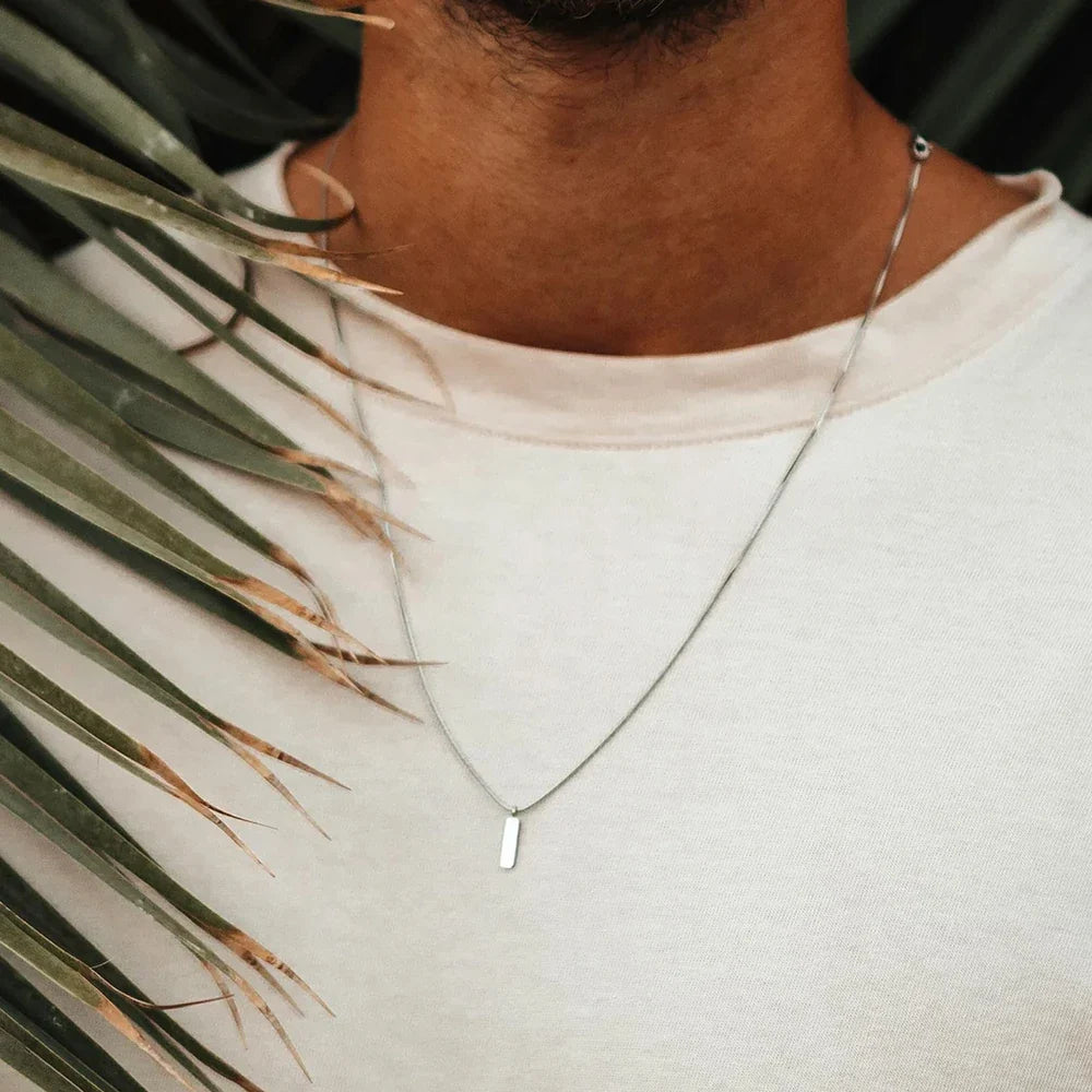 Stylish men's minimalist stainless steel bar pendant necklace. Modern jewelry for a clean look.