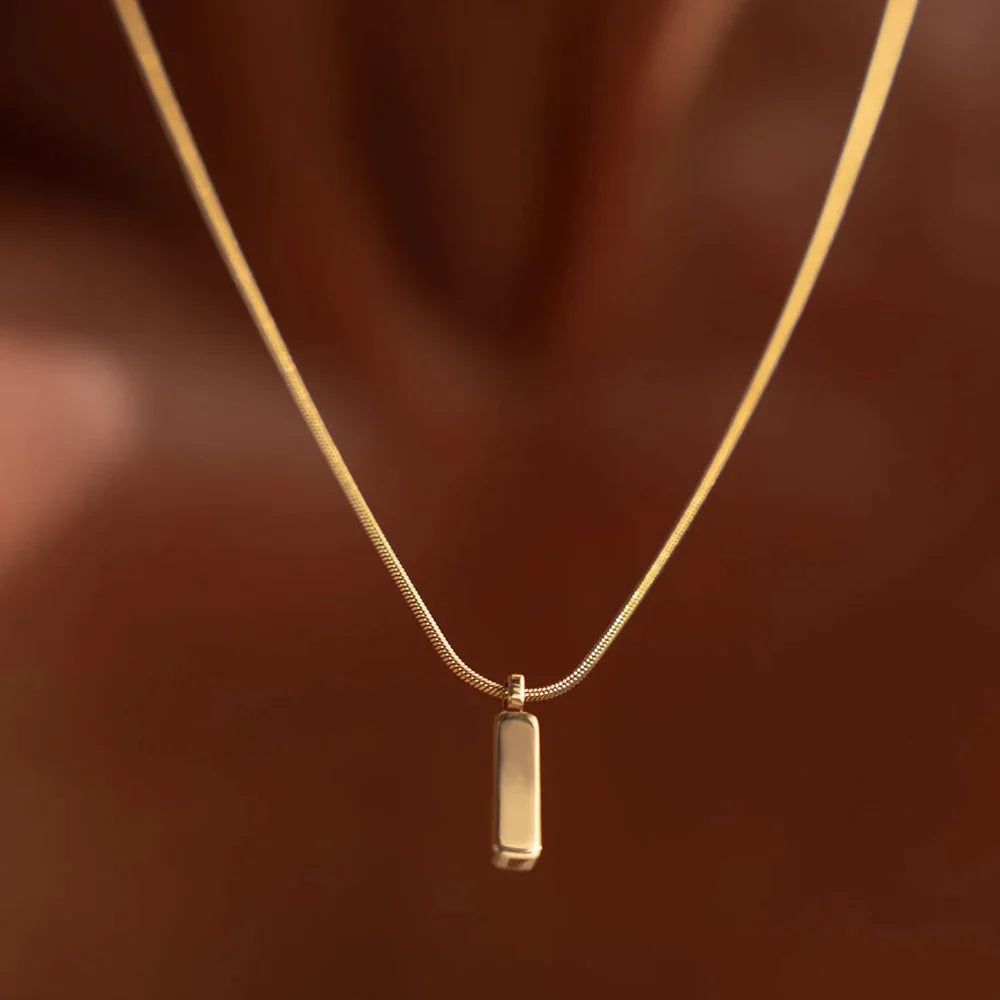 Gold men's bar pendant necklace. A minimalist stainless steel accessory, perfect for everyday wear.