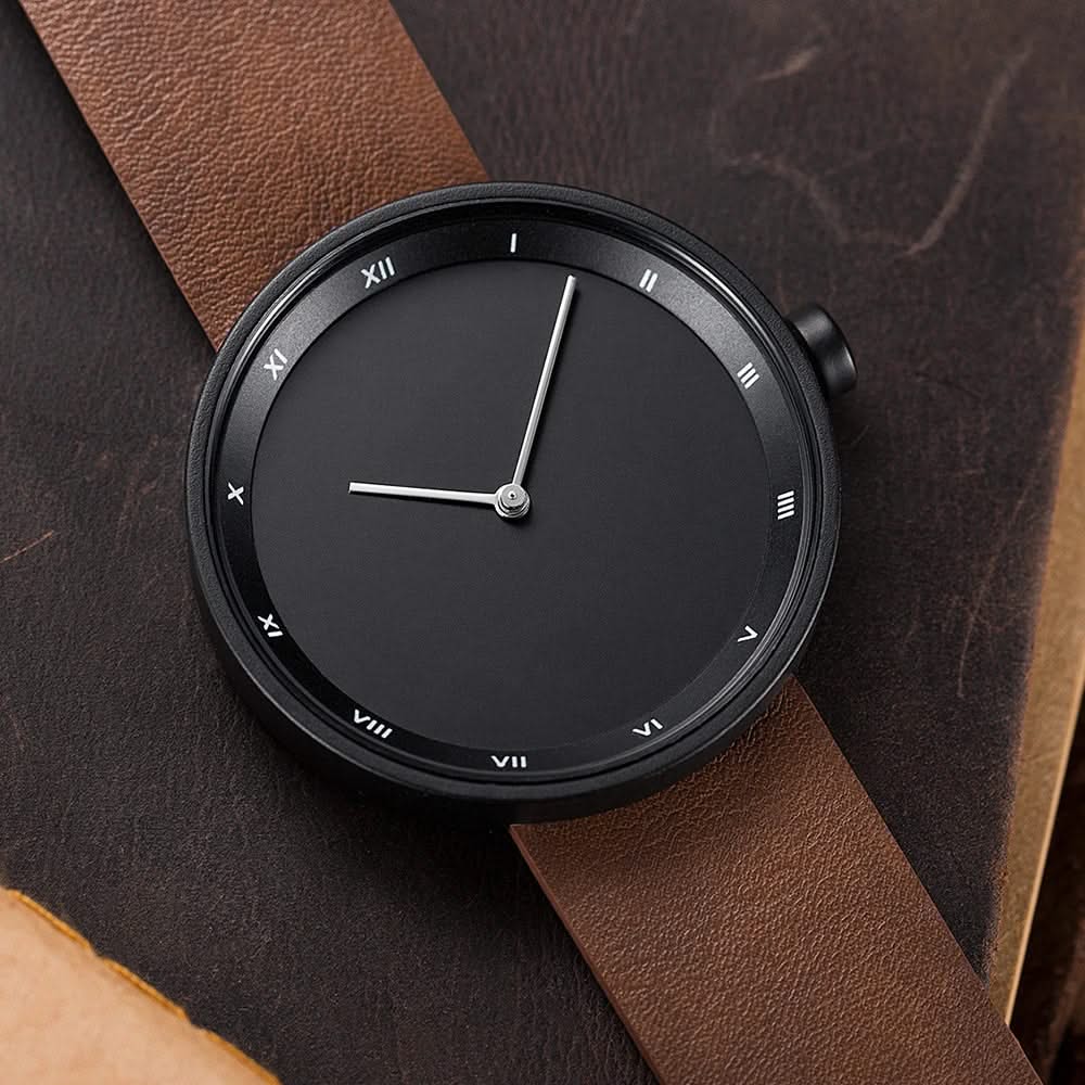 Sleek men's minimalist wrist watch with a leather strap, modern casual accessory.