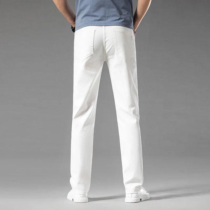 Clean white men's modern fit stretch denim jeans, a fresh option for contemporary casual outfits.