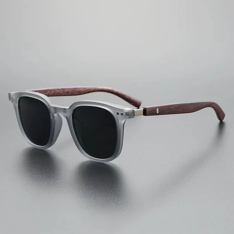 Close-up of men's Harbor View sunglasses, showcasing modern design & wood accent arms. Provides essential UV protection.