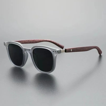 Close-up of men's Harbor View sunglasses, showcasing modern design & wood accent arms. Provides essential UV protection.