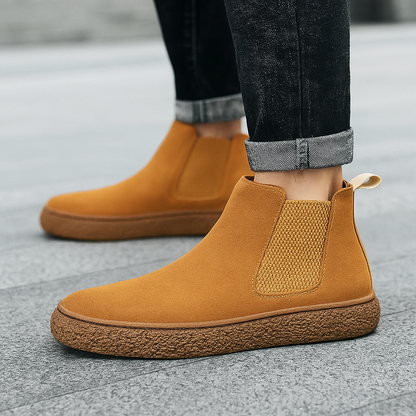 Side view of men's modern ridge Chelsea boots, highlighting sleek design & durable materials.