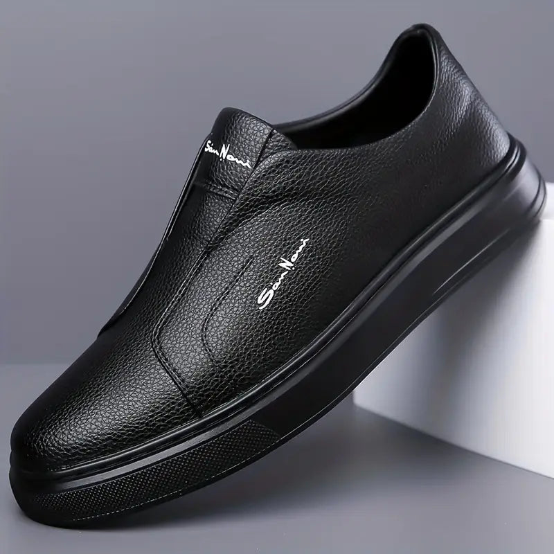 Front view of black men's slip-on sneakers, highlighting the sleek, no-lace modern style.