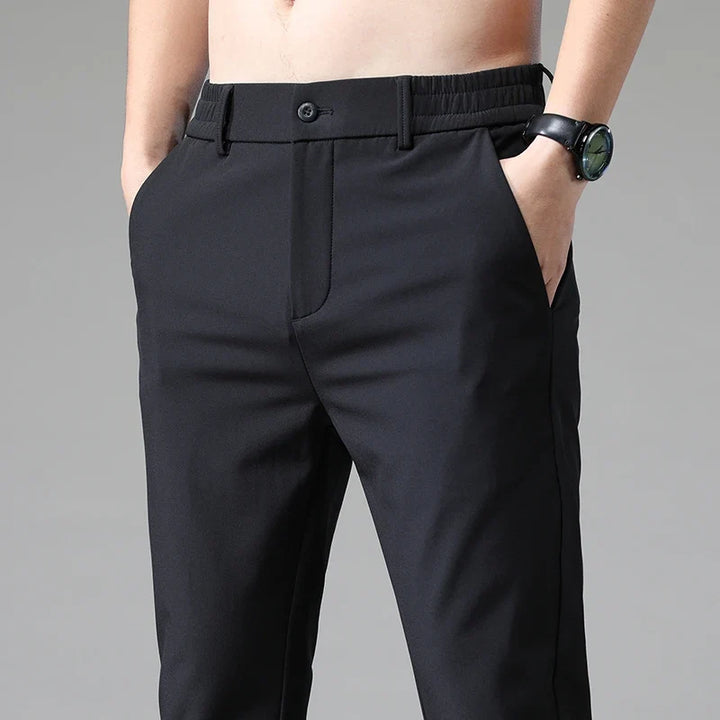 Men's modern straight fit performance pants in black, front view. Versatile for office or casual wear.
