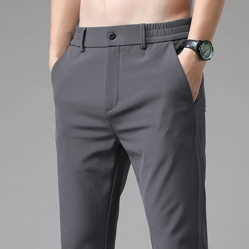 Close-up of stretchy, wrinkle-resistant fabric on men's performance pants. Tailored straight fit.