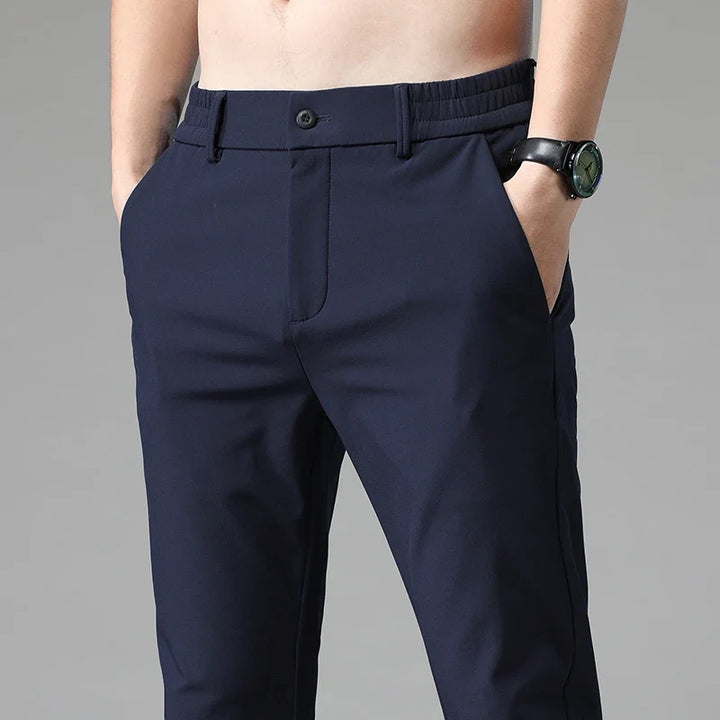 Man wearing modern straight fit performance pants casually with a t-shirt. Stretchy & comfortable.