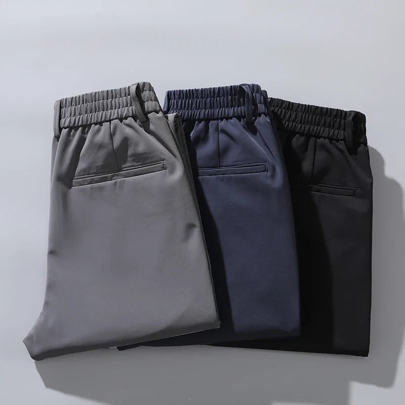 Professional man in tailored straight fit performance pants for office attire. Wrinkle-resistant style.