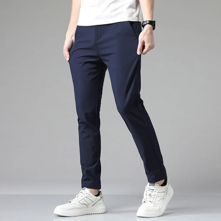 Back view of men's modern straight fit performance pants, showing tailored pockets. Stretchy & sleek.