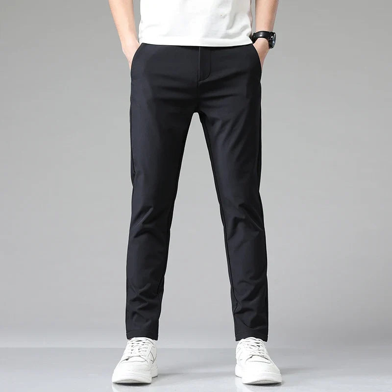 Folded men's modern performance pants, highlighting the wrinkle-resistant, stretchy fabric quality.