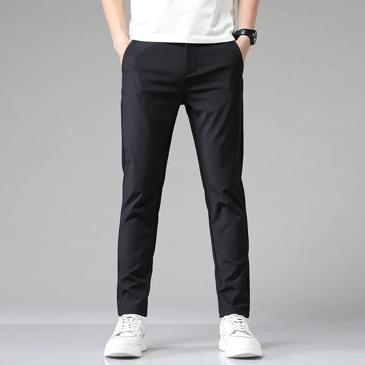 Folded men's modern performance pants, highlighting the wrinkle-resistant, stretchy fabric quality.