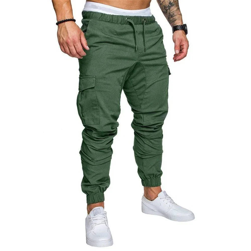 Stack of folded men's multi-pocket cargo pants in various colors: black, khaki, olive, utility trousers