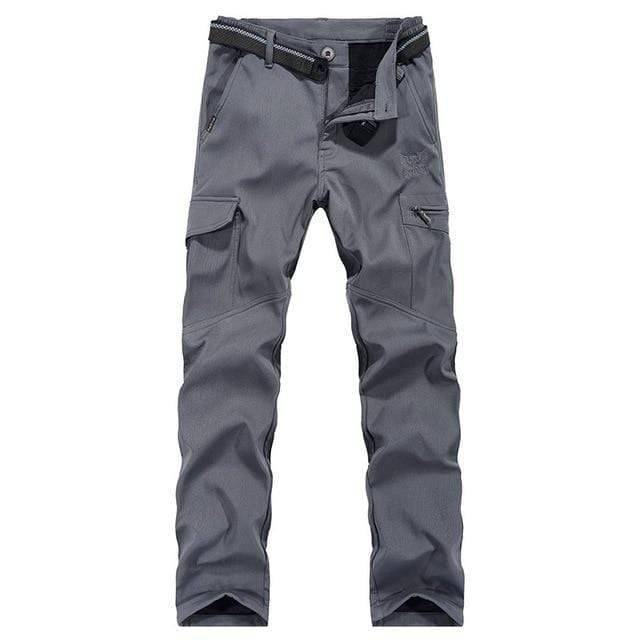 Man wearing mens outdoor tactical cargo pants while hiking, showcasing comfort and functionality.