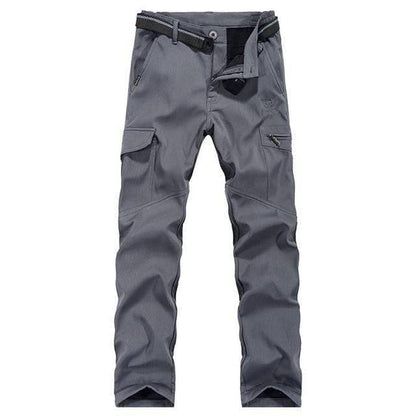 Man wearing mens outdoor tactical cargo pants while hiking, showcasing comfort and functionality.