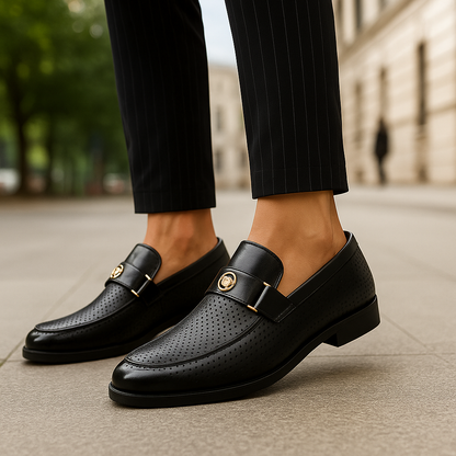 Detailed view of men's perforated loafers, highlighting breathable texture & refined slip-on footwear.