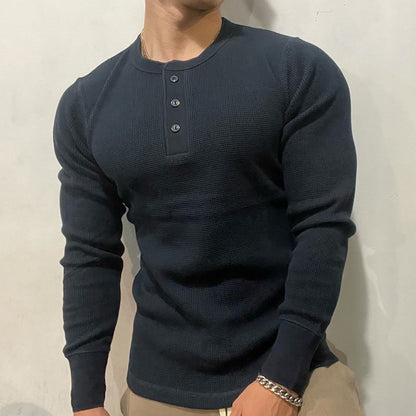 Close-up of the men's performance Henley muscle shirt fabric, highlighting its breathable, sweat-wicking properties.