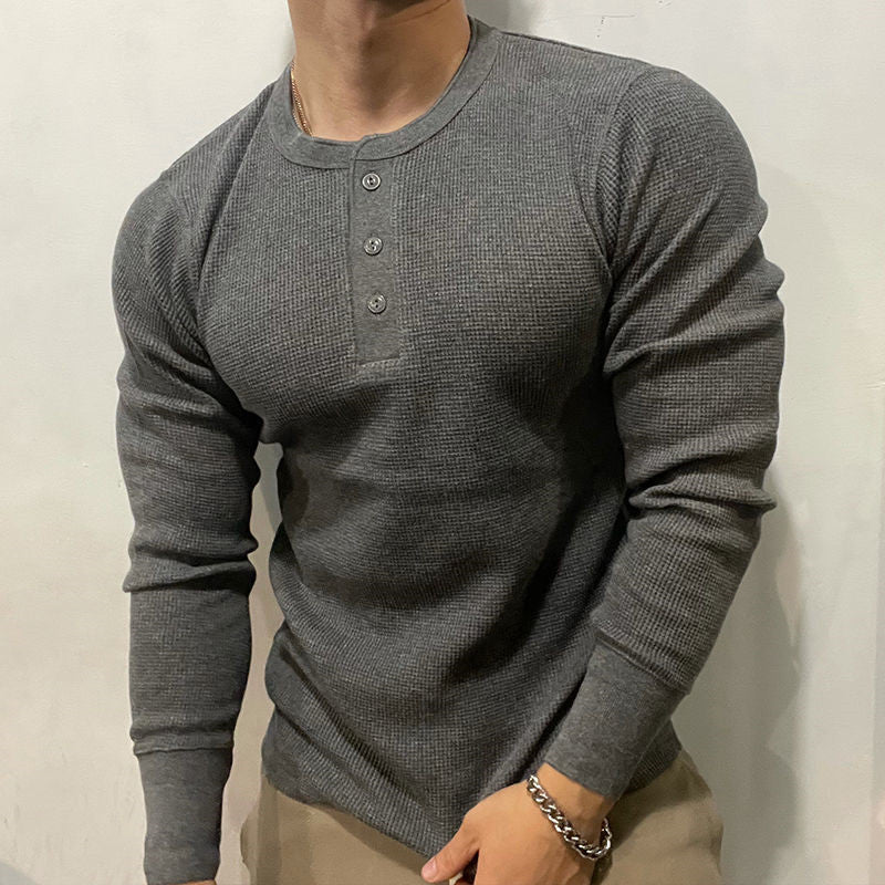 Man in a men's performance Henley muscle shirt. Perfect activewear for gym, sports, and casual comfort.