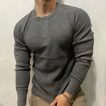 Man in a men's performance Henley muscle shirt. Perfect activewear for gym, sports, and casual comfort.