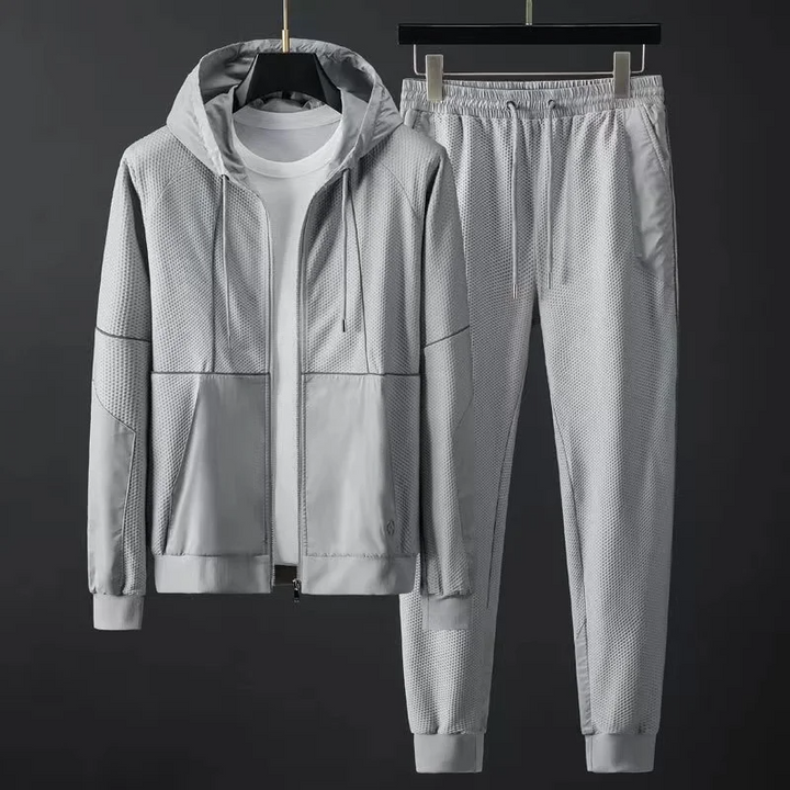 Men's techwear hoodie and tapered joggers set. Performance sportswear for ultimate comfort & modern style.