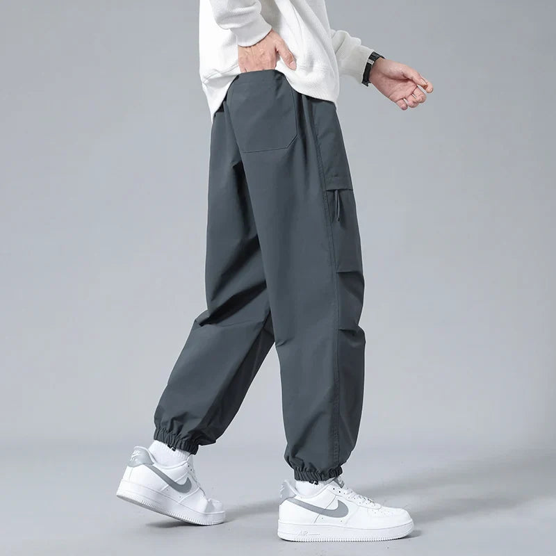 Men's cargo utility joggers featuring secure zippered pockets & flexible fabric for activewear & casual comfort.