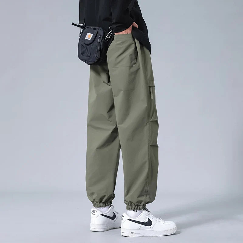 Man wearing comfortable & flexible men's utility joggers, perfect for active lifestyles & casual everyday wear.