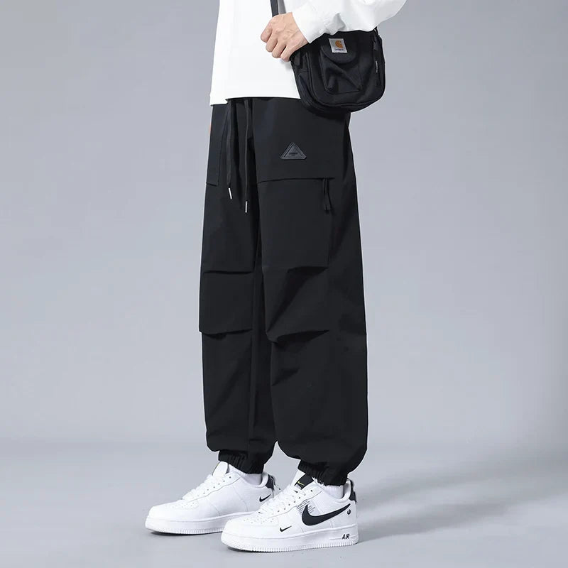 Close-up of secure zippered pockets on men's performance utility joggers, ideal for storing essentials on the go.