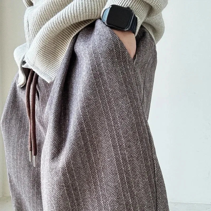 Stylish men's pinstripe relaxed fit pants, featuring a practical drawstring waist for comfort and modern appeal.