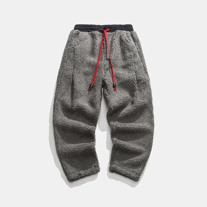 Men's plush sherpa fleece joggers with pockets, warm, comfortable, and practical winter loungewear.