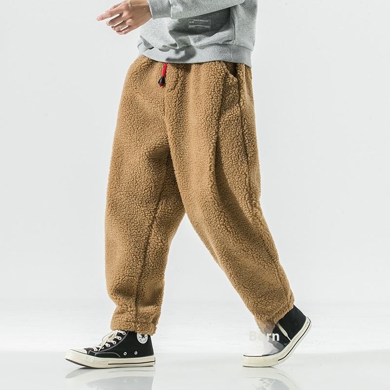 Man wearing relaxed fit plush sherpa fleece joggers, ideal warm loungewear for casual comfort & winter.