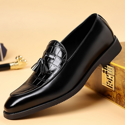 Men's polished black tassel loafers; sharp, confident formal dress shoes with classic style.
