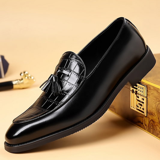 Men's polished black tassel loafers; sharp, confident formal dress shoes with classic style.